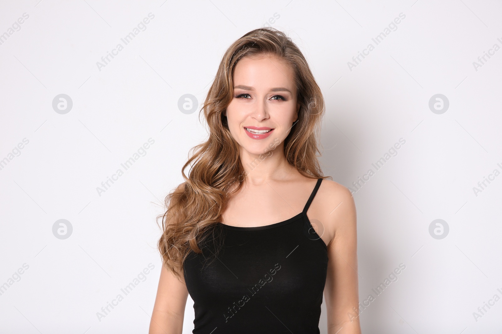 Photo of Portrait of young woman with long beautiful hair on light background