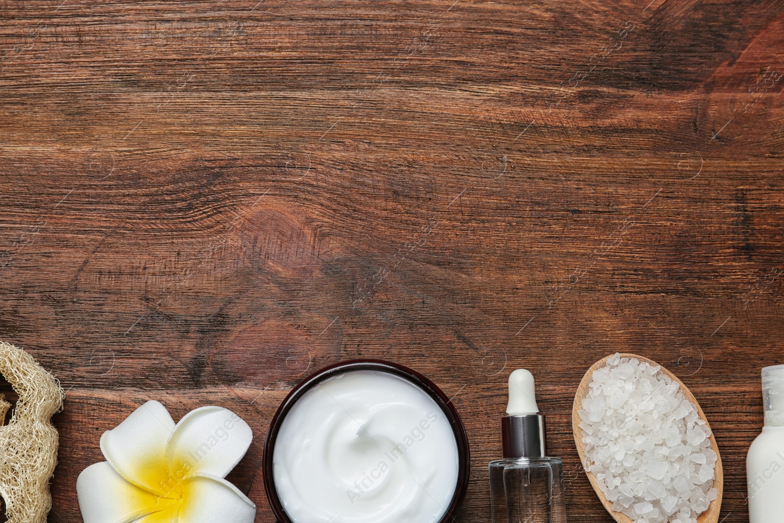 Photo of Flat lay composition with body care products and space for text on wooden background