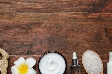 Flat lay composition with body care products and space for text on wooden background