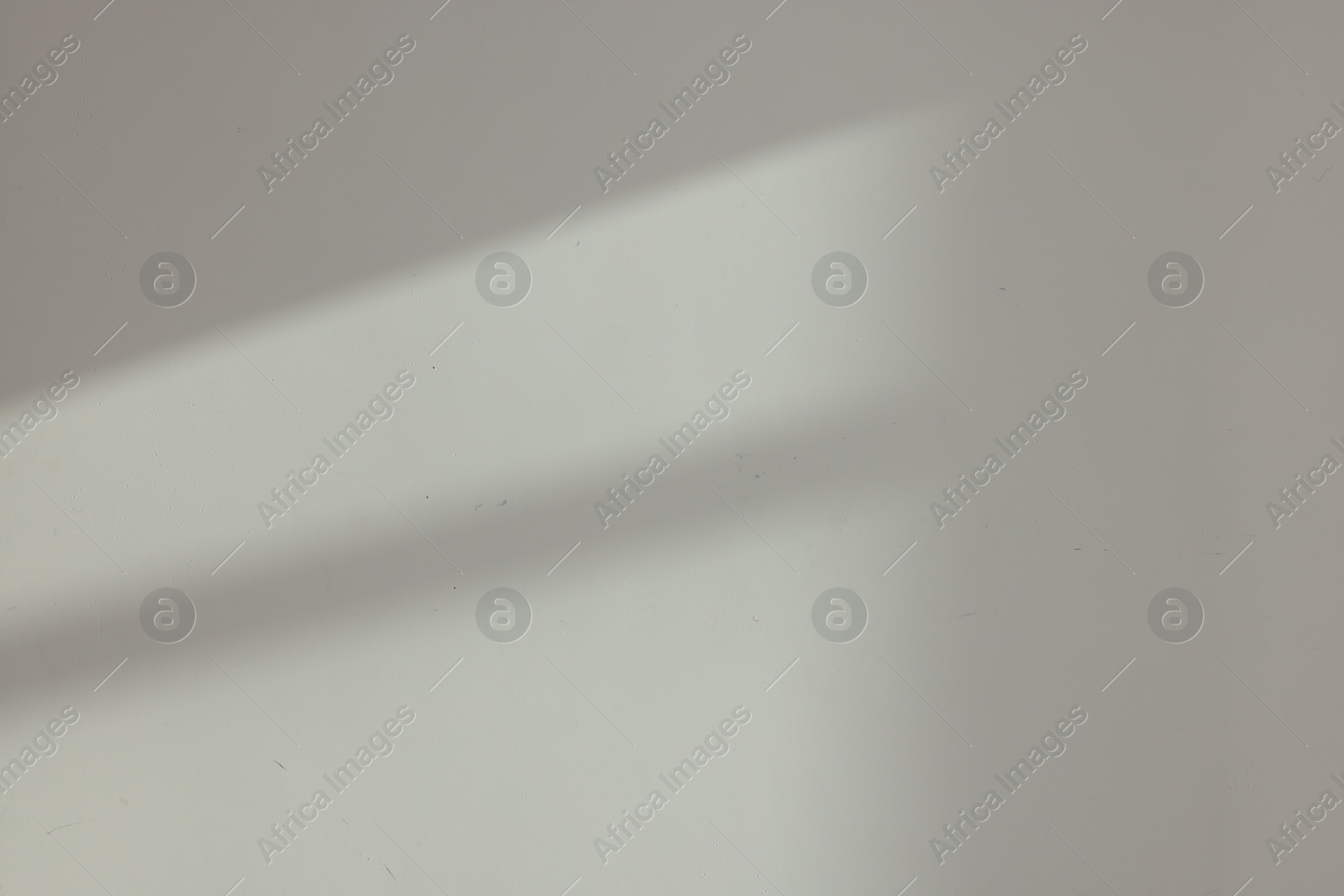 Photo of Light and shadows from window on wall indoors