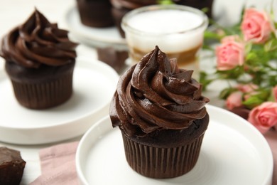 Plate with delicious chocolate cupcake on table, closeup