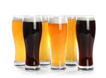 Photo of Glasses with different beer on white background