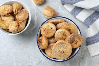 Photo of Tasty dried figs on light grey marble table, flat lay