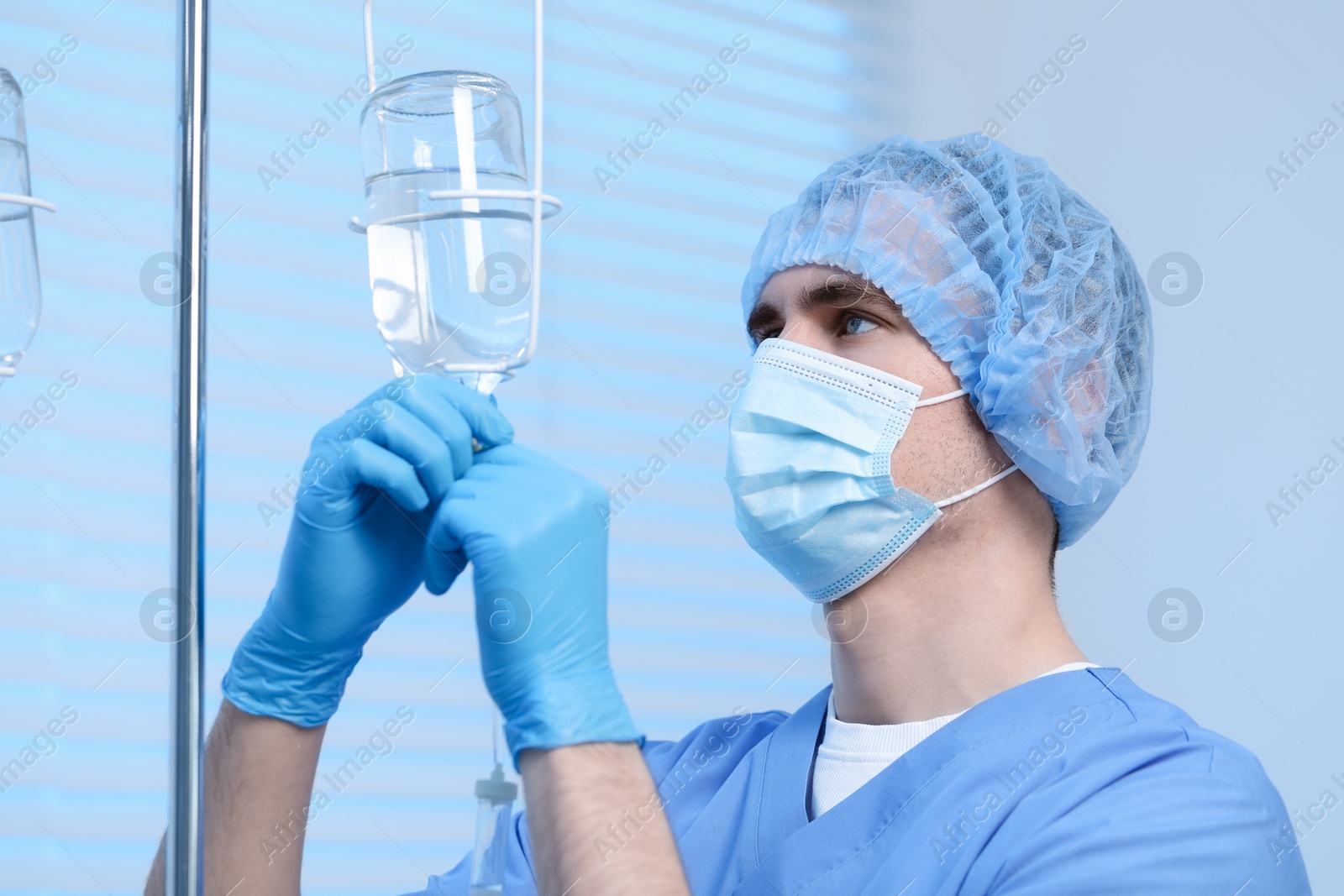 Photo of Nurse setting up IV drip in hospital