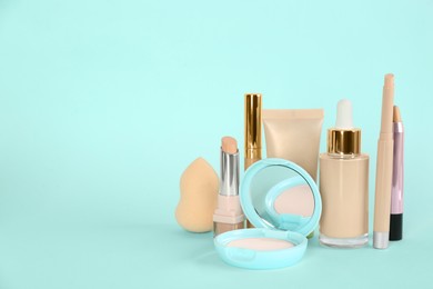 Foundation makeup products on turquoise background, space for text. Decorative cosmetics