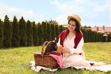 Happy woman having picnic in green park