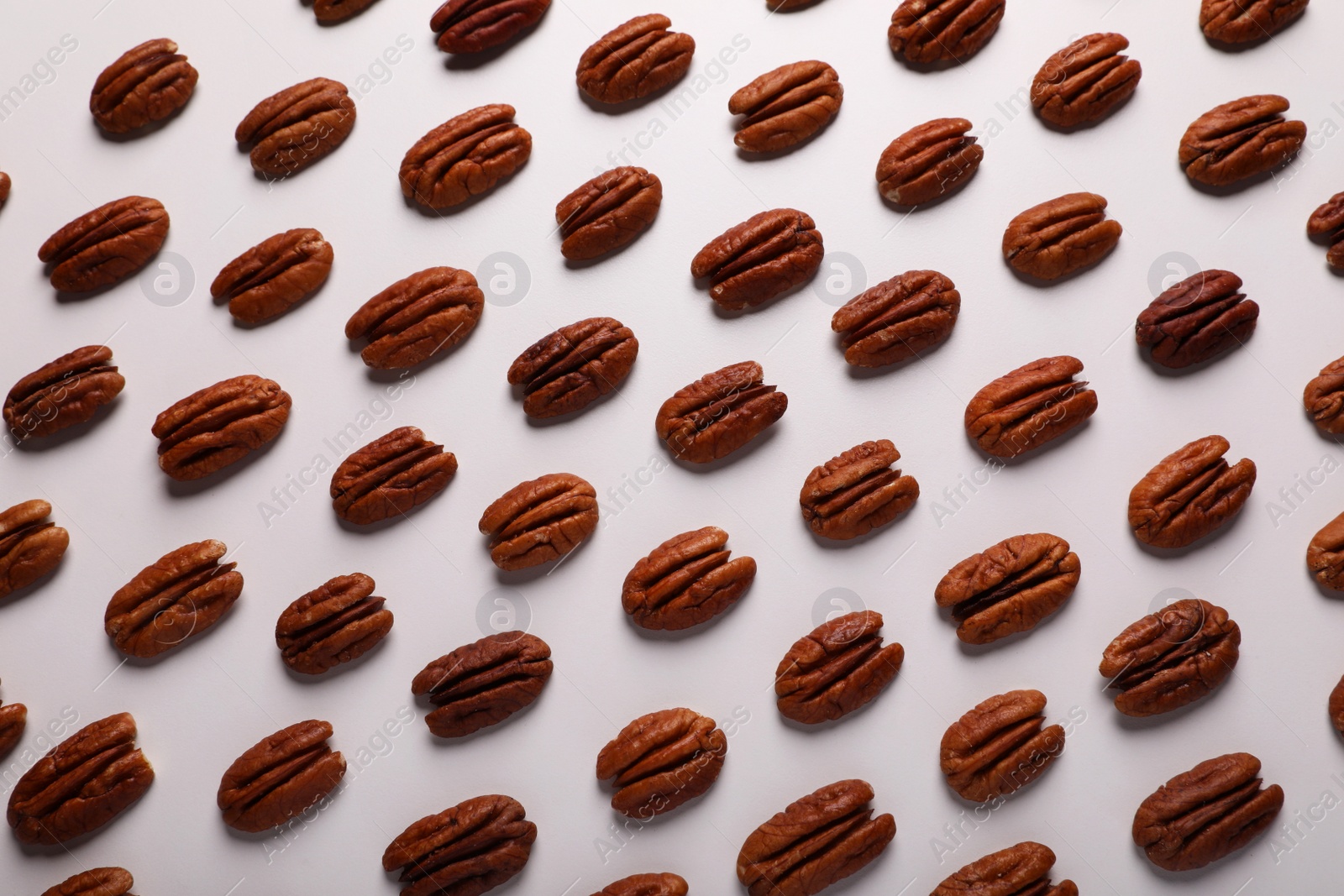 Photo of Delicious fresh pecan nuts on white background, flat lay