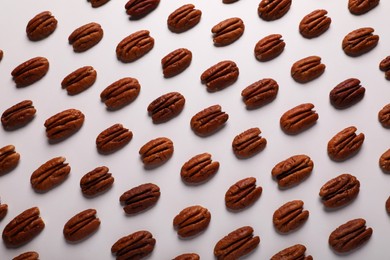 Delicious fresh pecan nuts on white background, flat lay