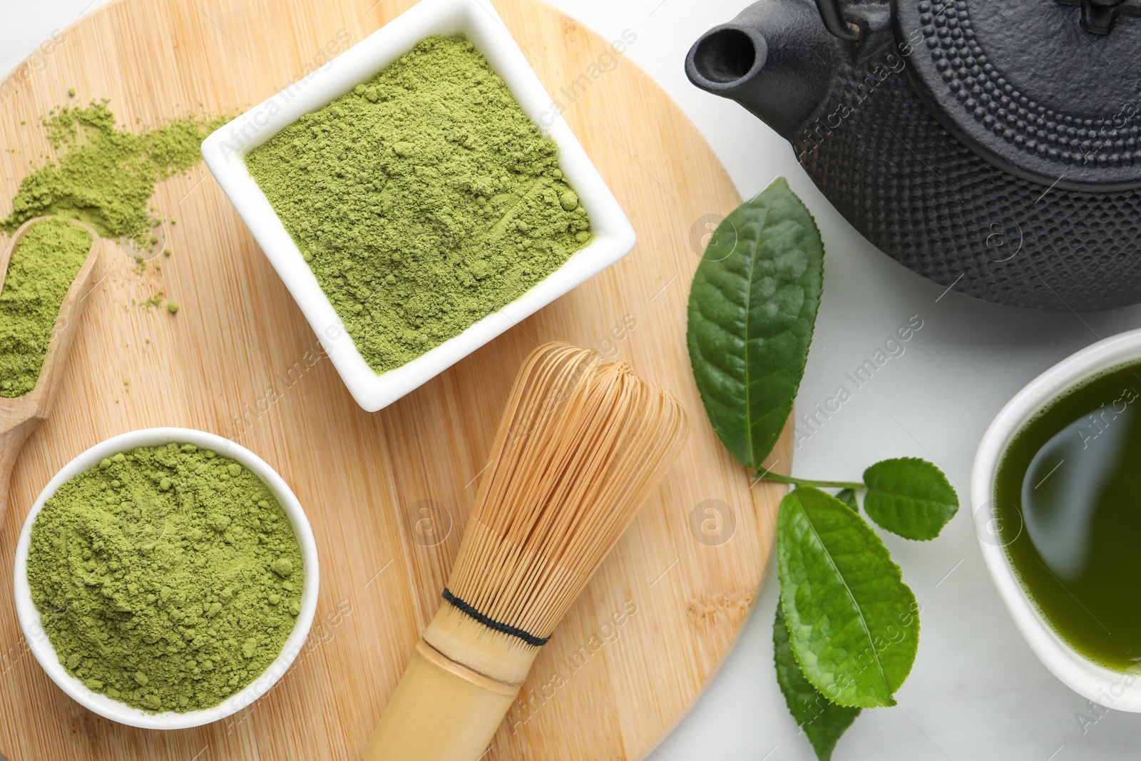 Photo of Flat lay composition with green matcha powder on white marble table