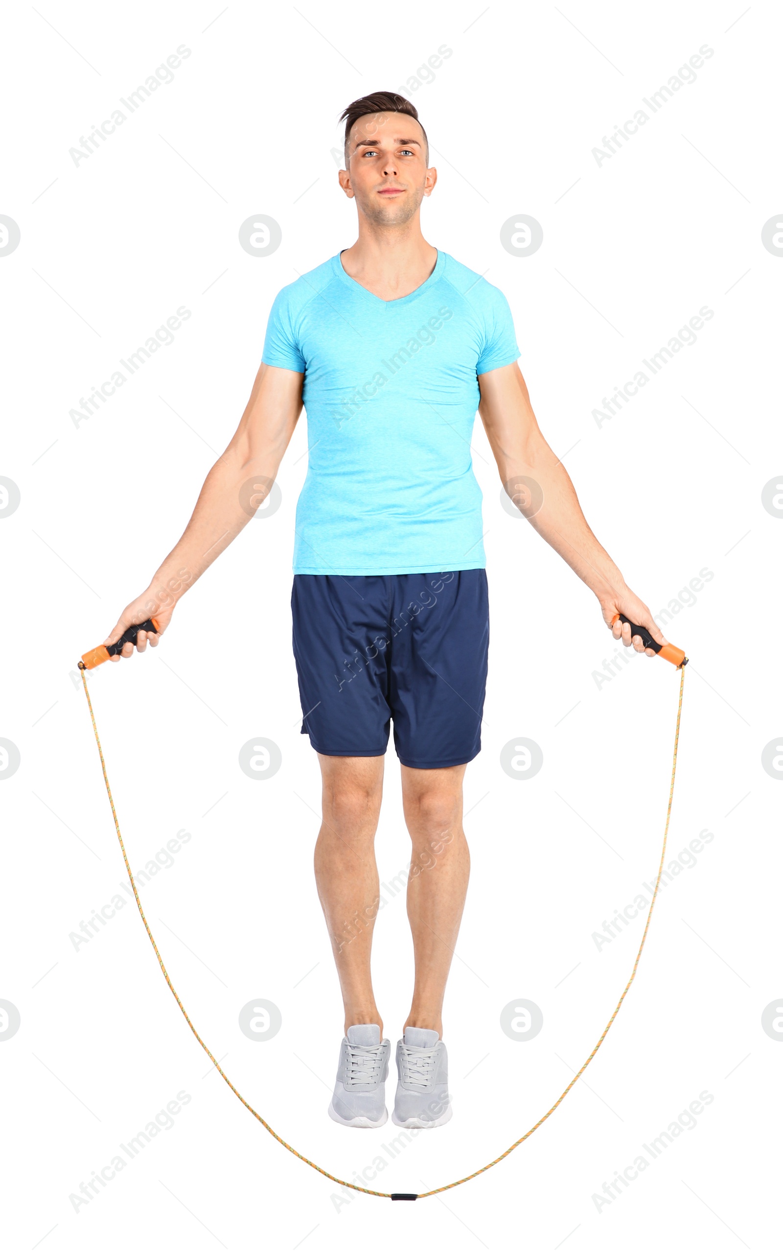 Photo of Full length portrait of young sportive man training with jump rope on white background