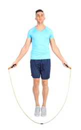 Photo of Full length portrait of young sportive man training with jump rope on white background