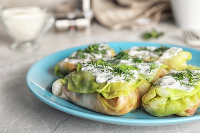 Photo of Plate with delicious cabbage rolls on table, closeup