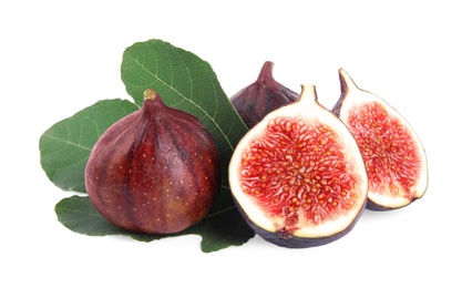 Photo of Fresh juicy purple figs and green leaves on white background