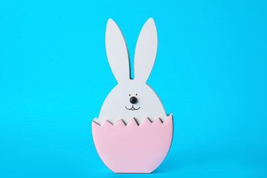 Photo of Bunny figure as Easter decor on blue background