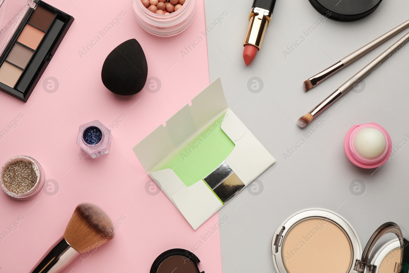 Photo of Flat lay composition with facial oil blotting tissues and makeup products on color background. Mattifying wipes