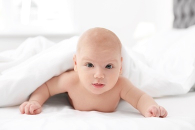 Photo of Adorable baby girl lying in bed