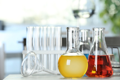 Image of Laboratory glassware with different liquid samples on table