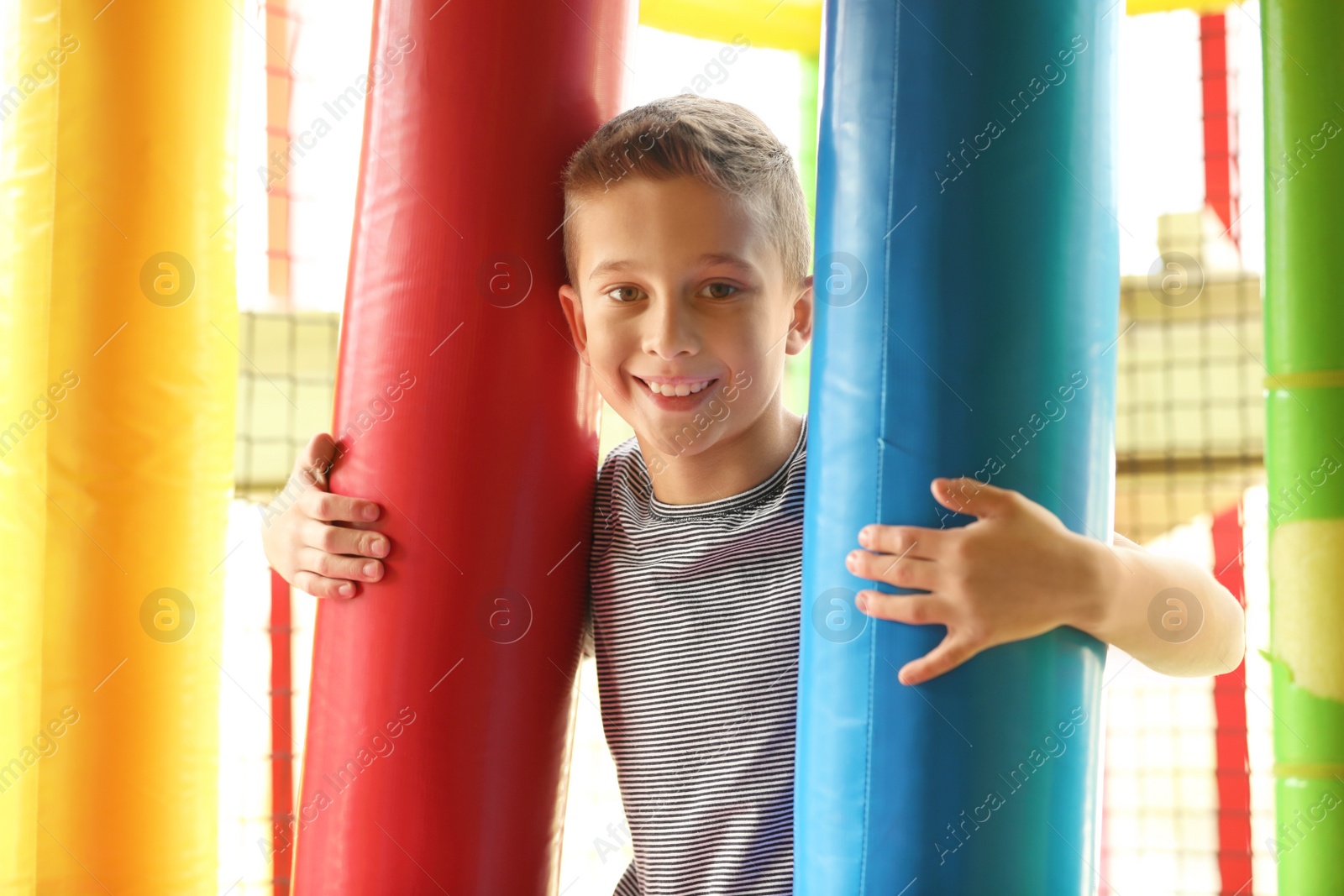 Photo of Cute little child playing at indoor amusement park