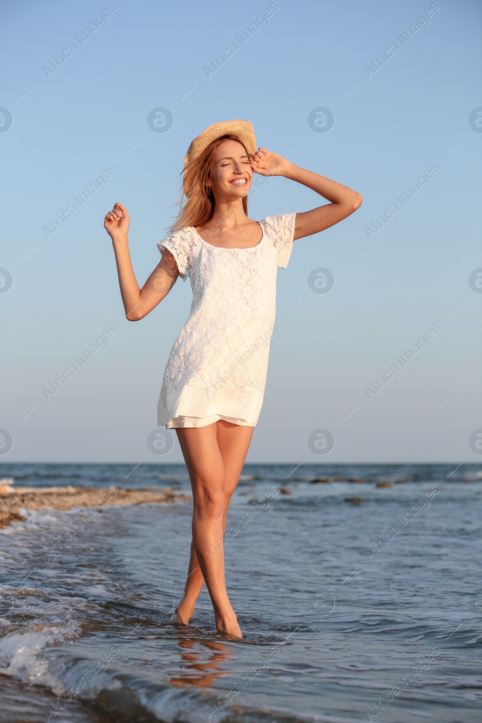 Photo of Young woman enjoying sunny day on beach