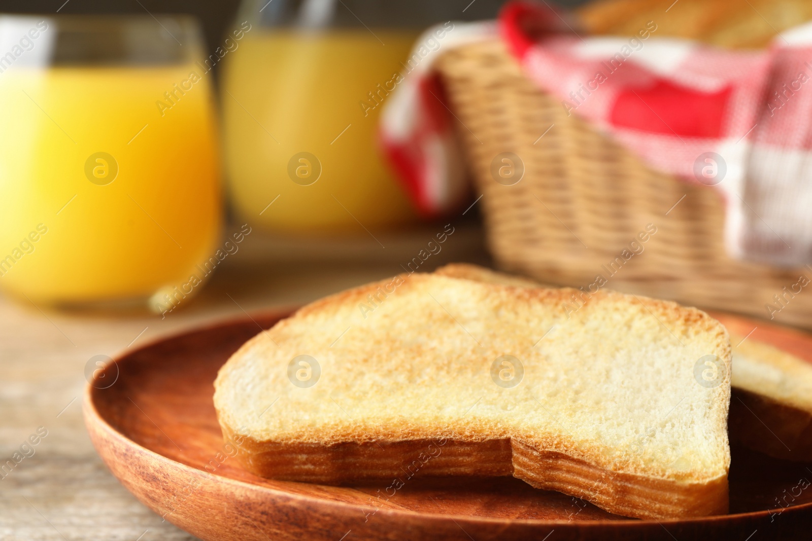 Photo of Slices of toasted bread on wooden table, closeup