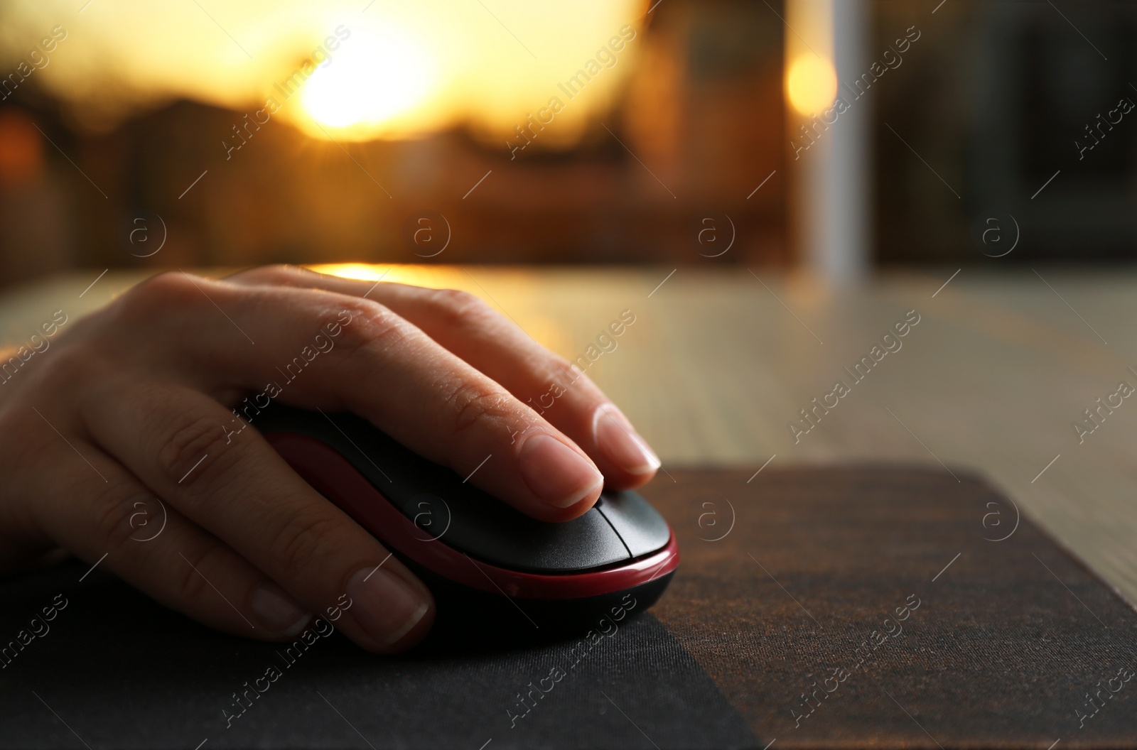 Photo of Woman using computer mouse at table, closeup. Space for text