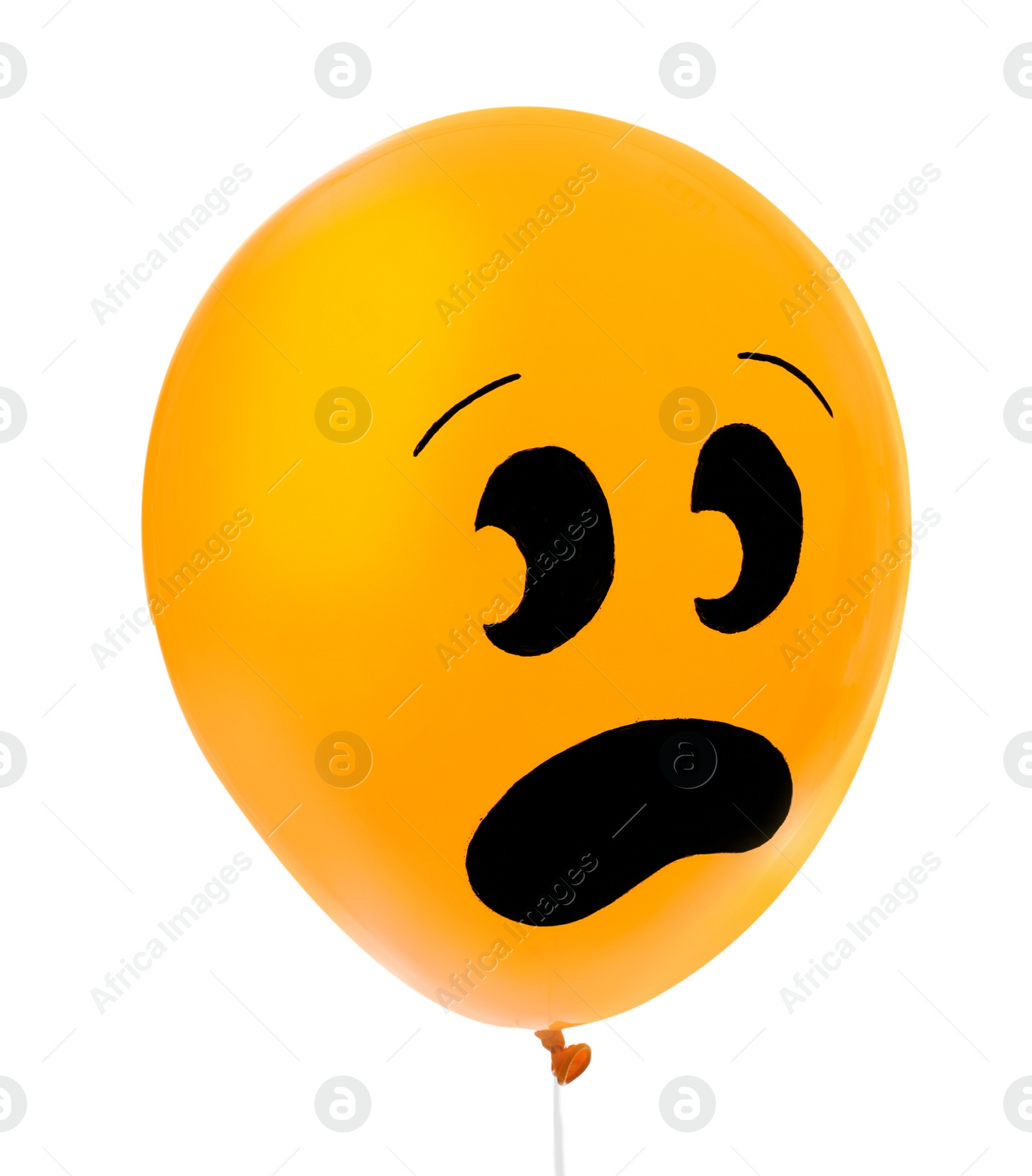Photo of Orange balloon with drawing of scared face on white background. Halloween party