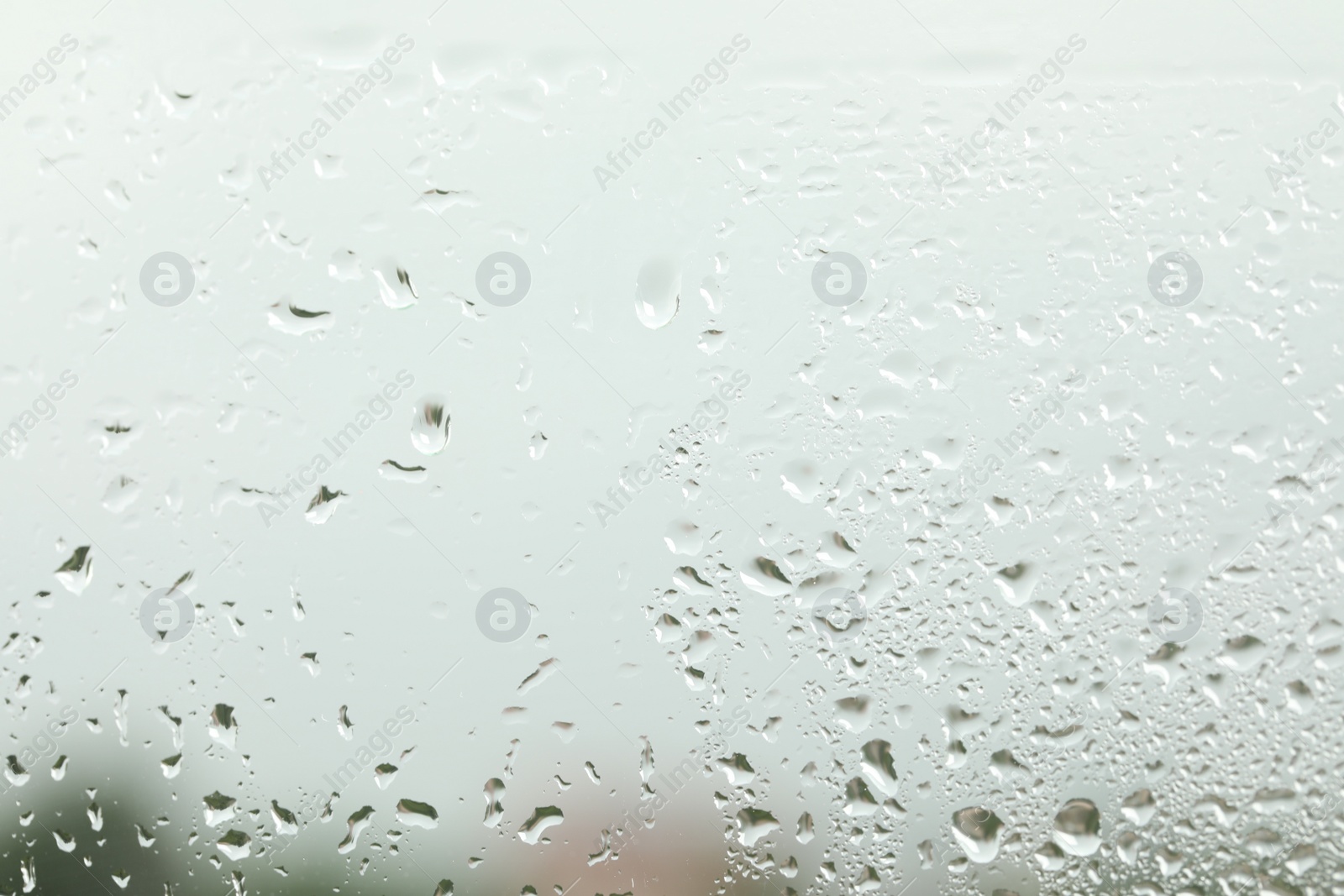 Photo of Window glass with raindrops as background, closeup