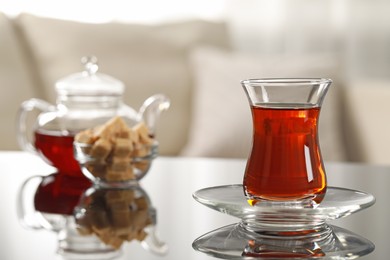 Photo of Glass of traditional Turkish tea on table indoors, space for text