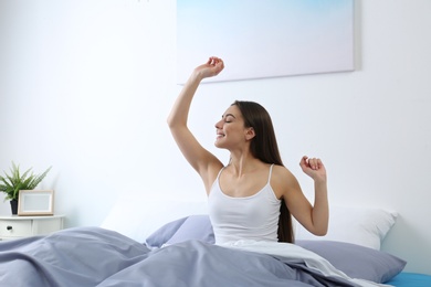 Young woman stretching at home in morning. Bedtime