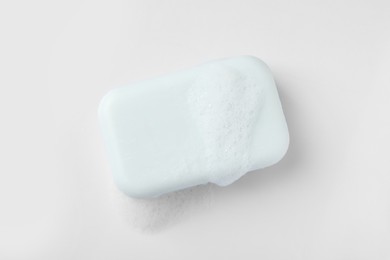 Photo of Soap with fluffy foam on white background, top view