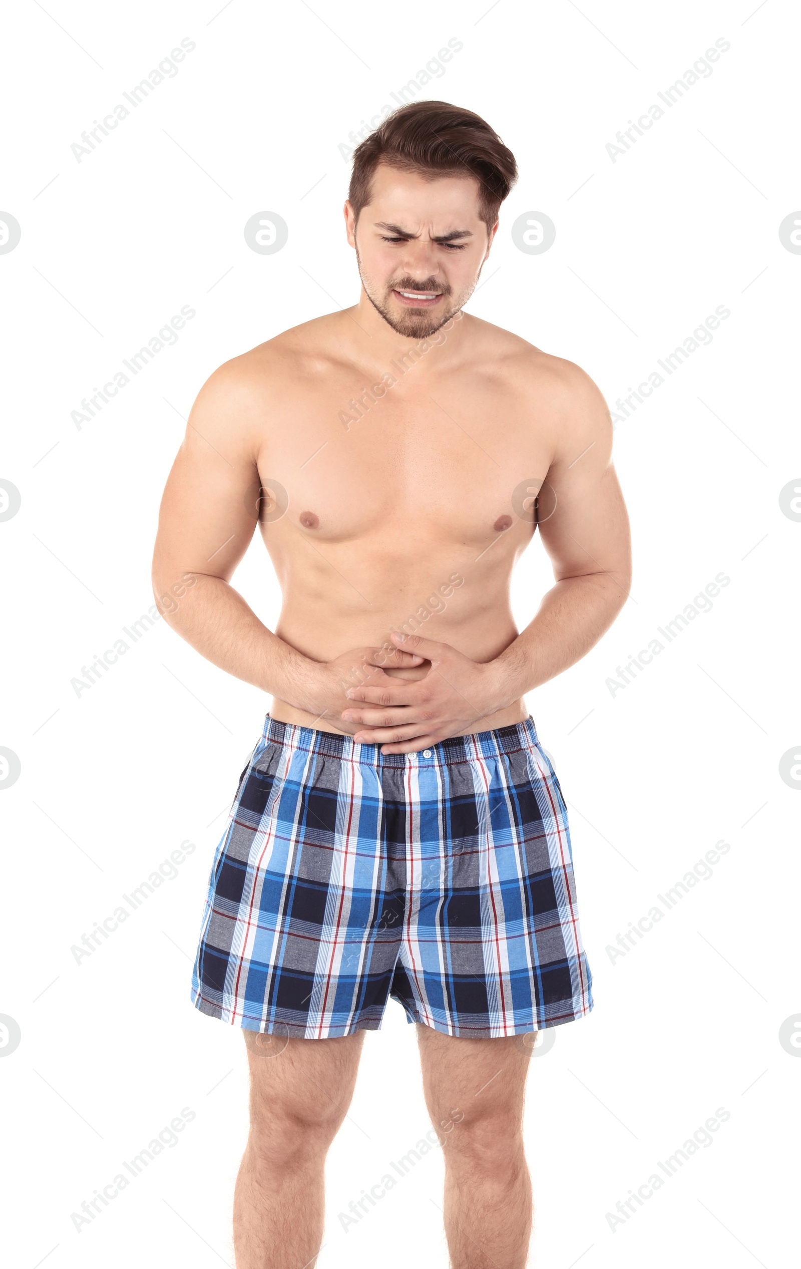 Photo of Young man with urological problems suffering from pain on white background