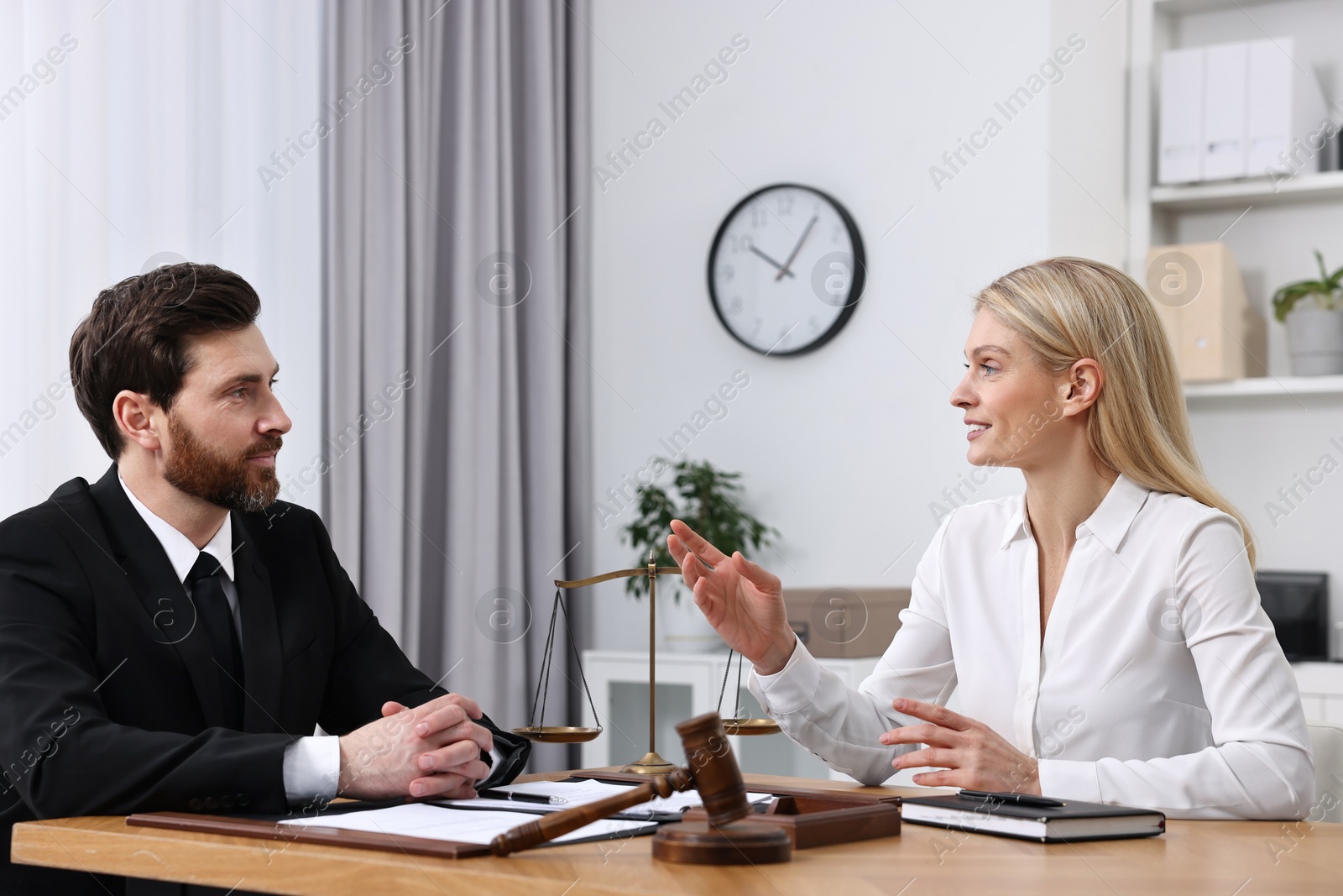 Photo of Woman having meeting with lawyer in office