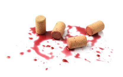 Bottle corks with wine stains on white background