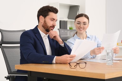 Businesspeople working together with documents in office