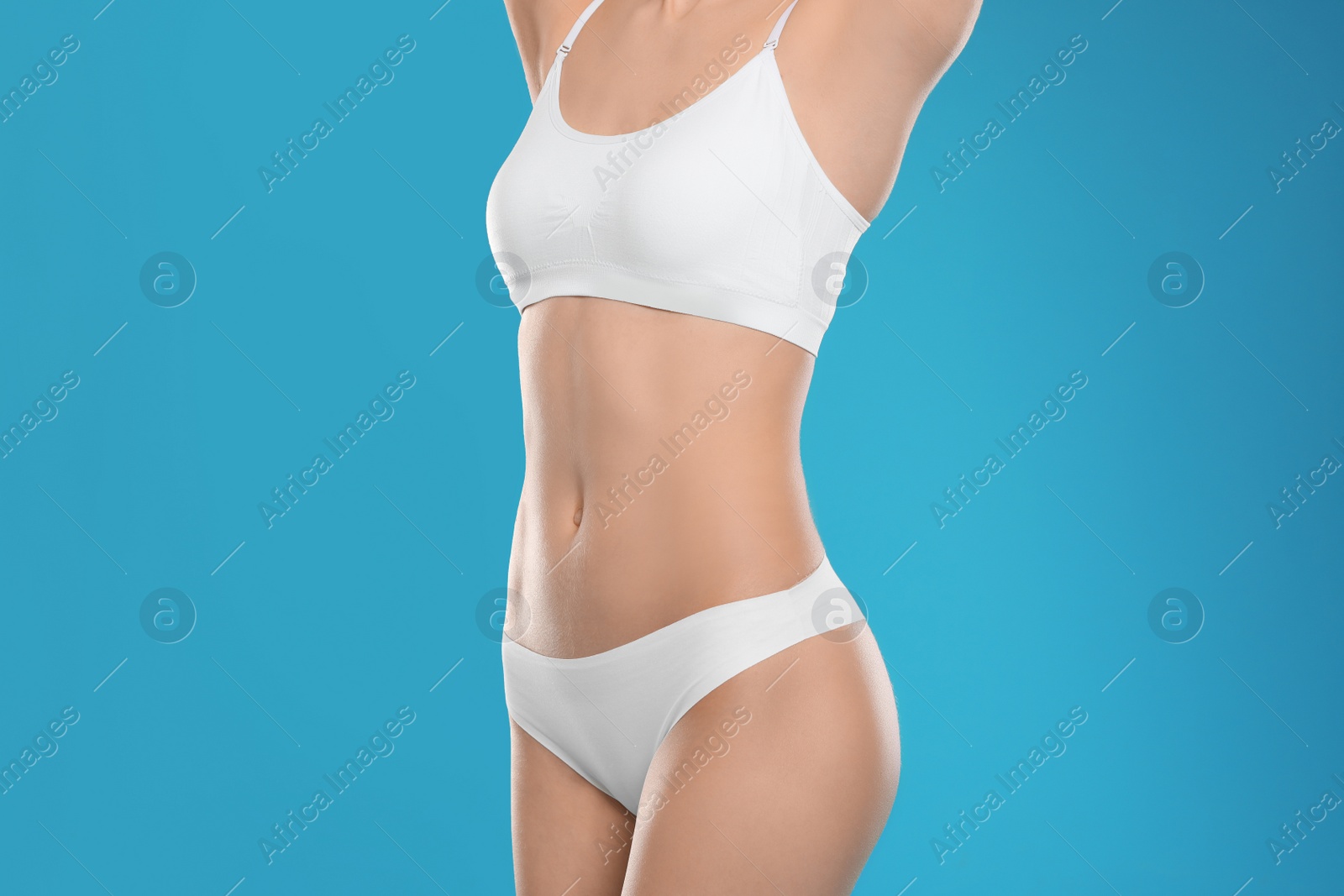 Photo of Slim young woman with smooth gentle skin on color background. Beauty and body care concept