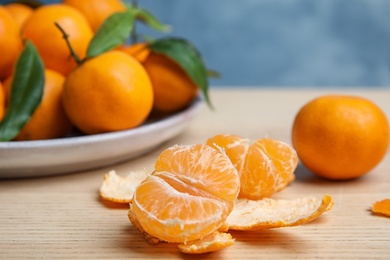 Photo of Fresh ripe tangerines on table. Citrus fruit