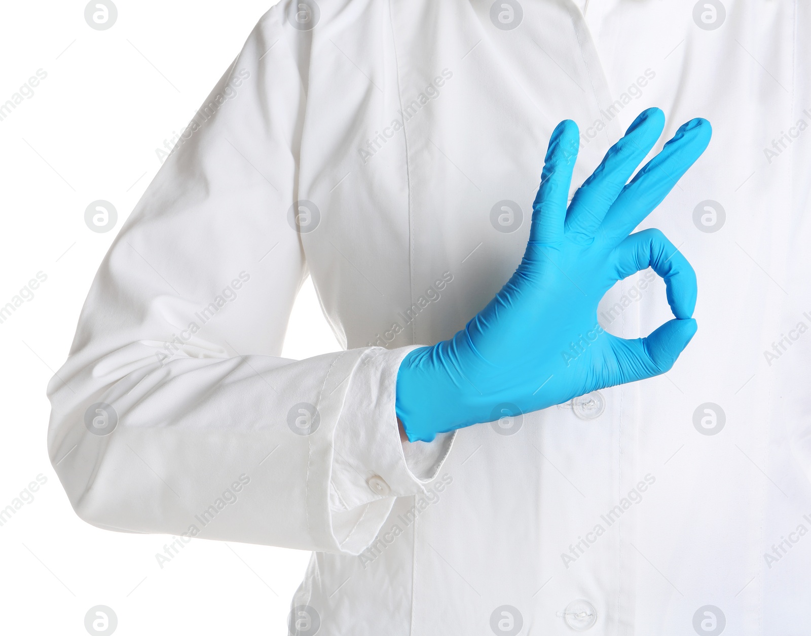 Photo of Doctor in medical glove showing OK gesture on white background