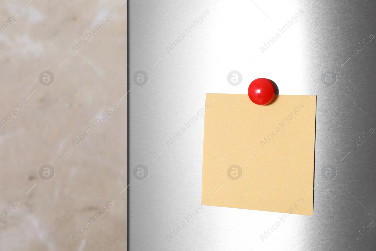 Photo of Blank note with magnet on refrigerator door. Space for text