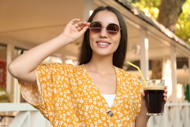 Beautiful woman with cold kvass outdoors. Traditional Russian summer drink