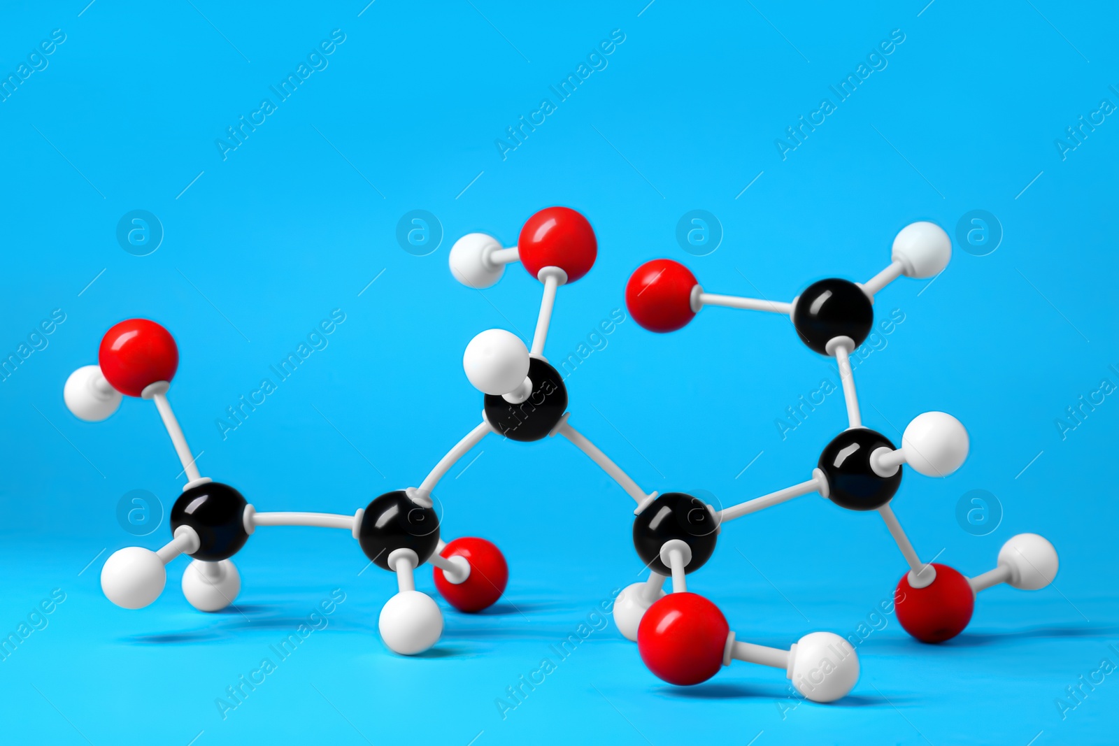 Photo of Molecule of glucose on light blue background. Chemical model