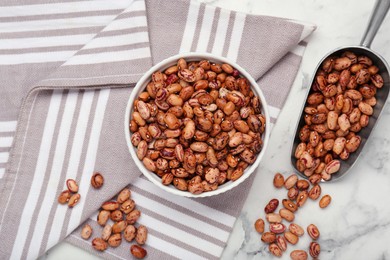 Many dry kidney beans on white marble table, flat lay