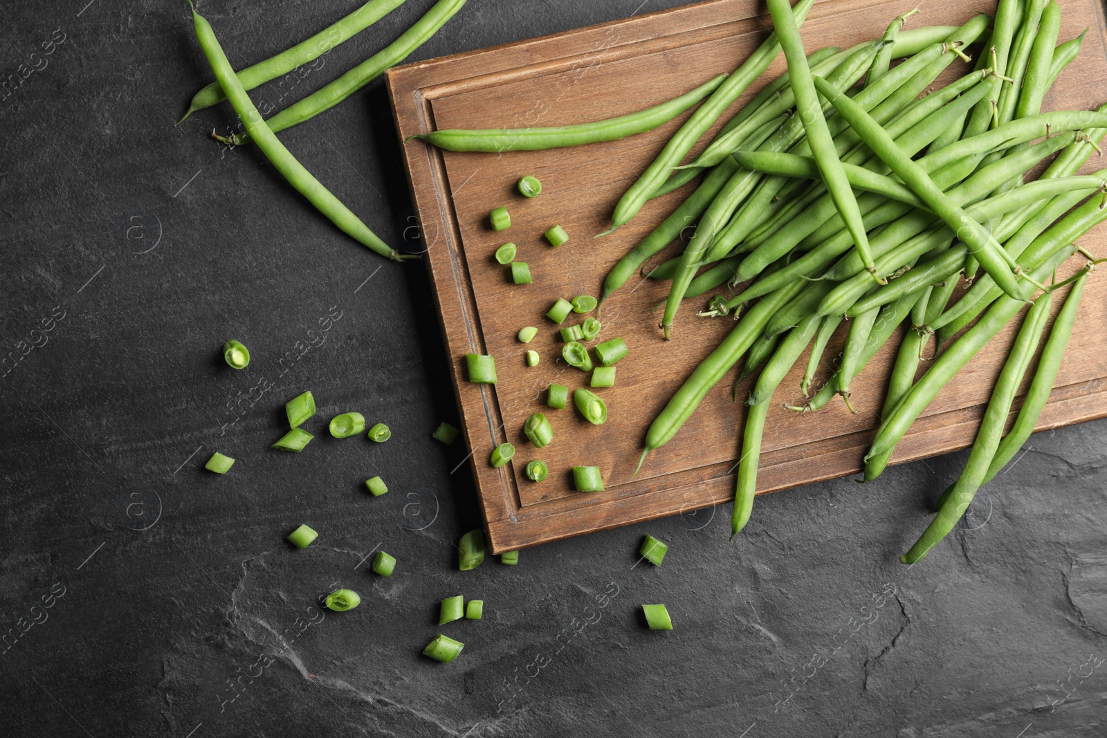 Photo of Fresh green beans on black table, flat lay