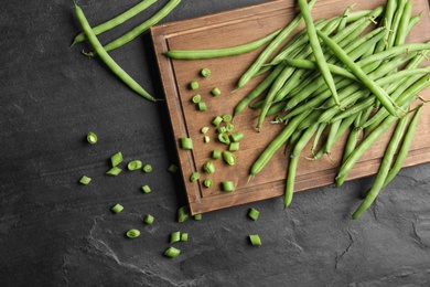 Fresh green beans on black table, flat lay