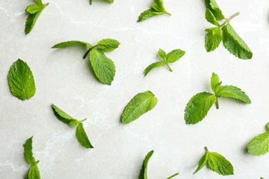 Fresh mint leaves on grey marble background, flat lay