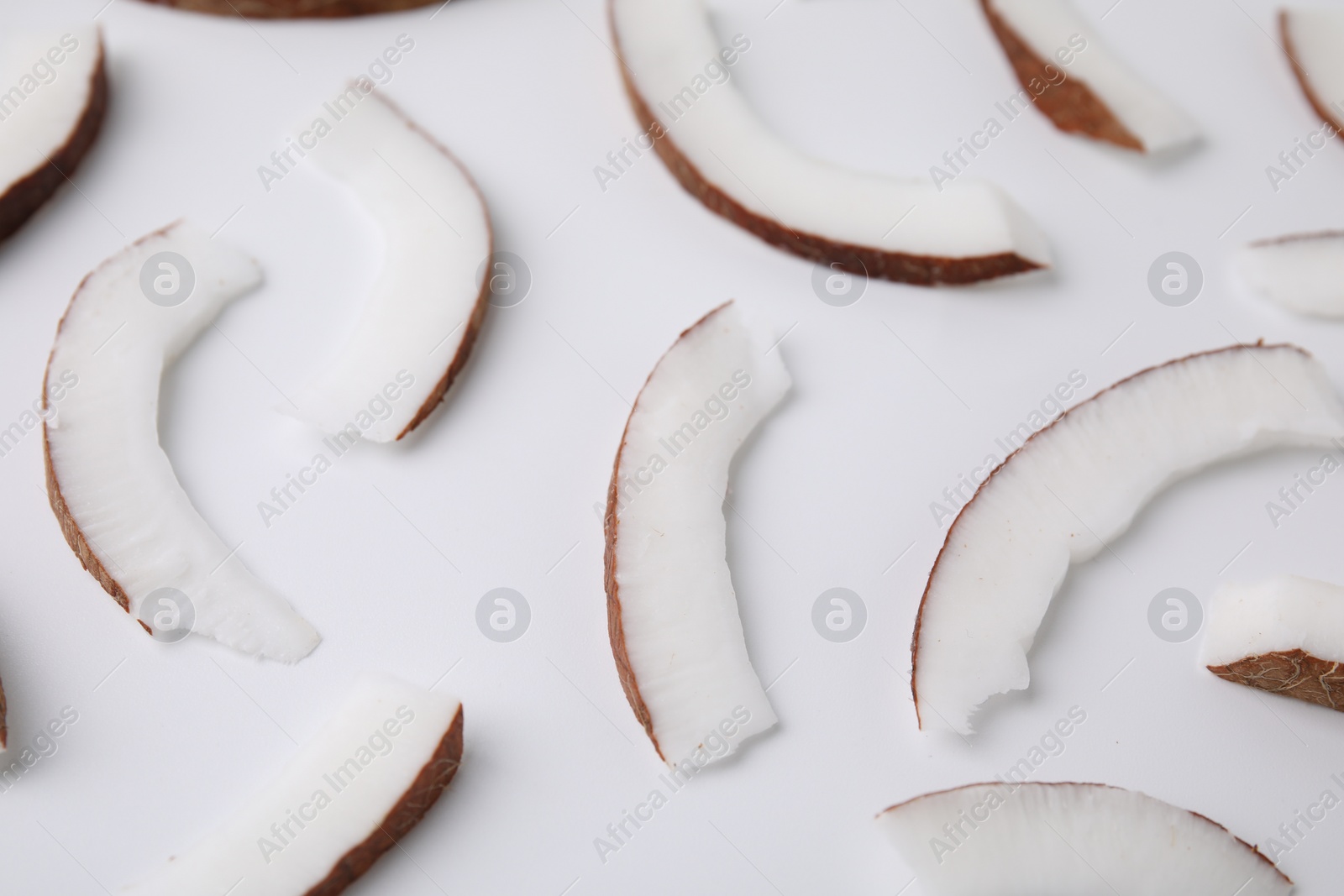 Photo of Pieces of fresh coconut on white background, closeup