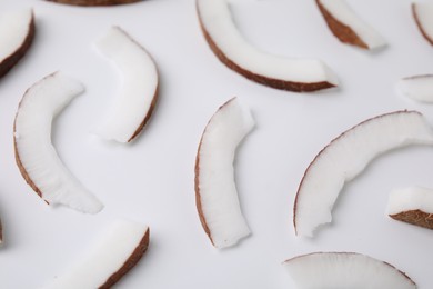 Pieces of fresh coconut on white background, closeup