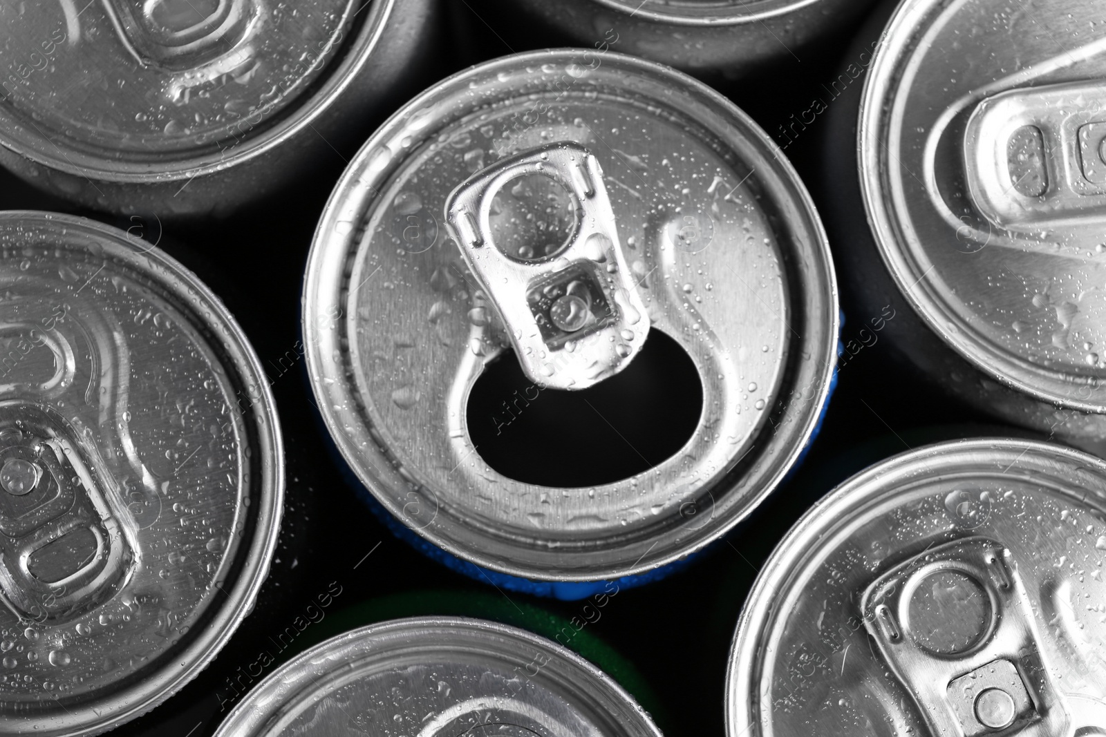 Photo of Energy drinks in wet cans as background, top view. Functional beverage