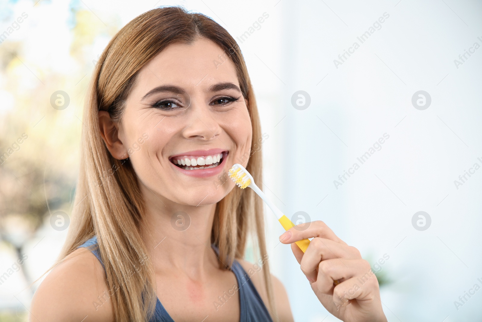 Photo of Portrait of woman with toothbrush on blurred background, space for text. Personal hygiene