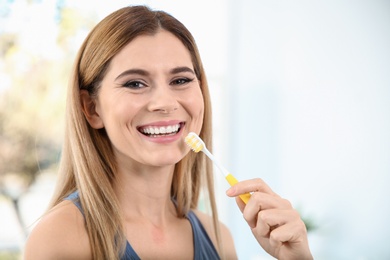 Photo of Portrait of woman with toothbrush on blurred background, space for text. Personal hygiene