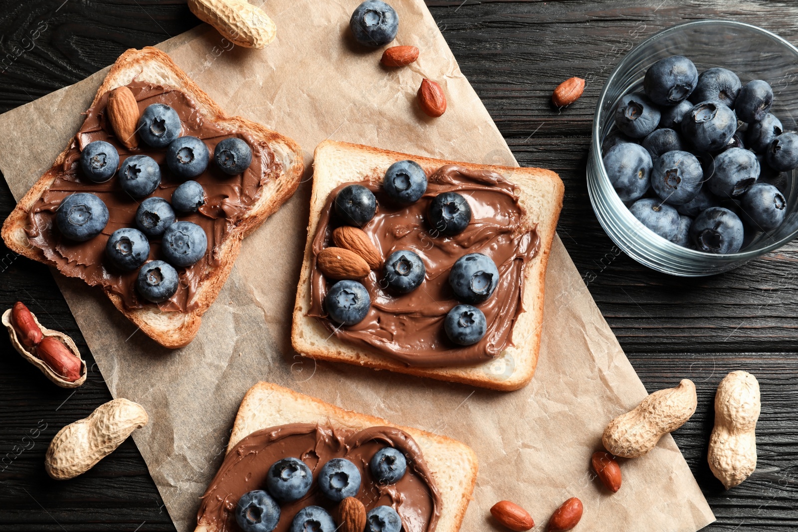 Photo of Toast bread with chocolate spread and blueberry on dark background